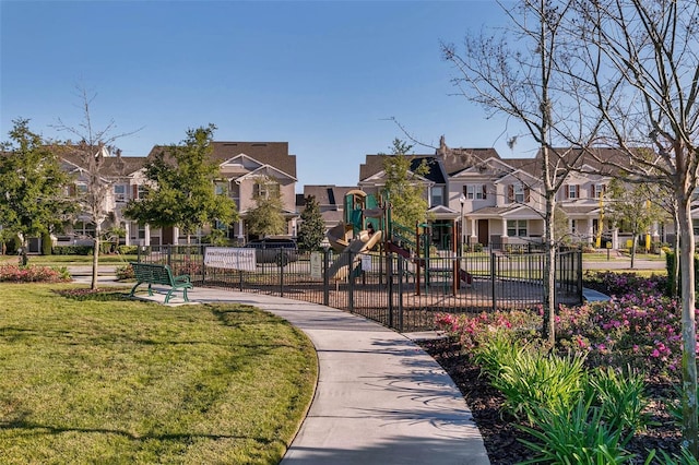 view of property's community featuring a yard and a playground