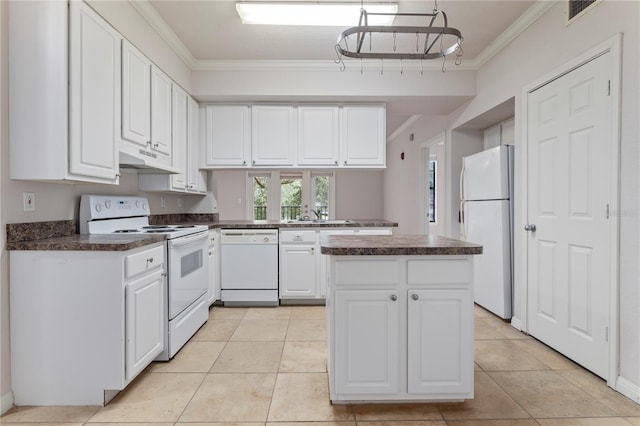 kitchen with light tile patterned floors, white appliances, white cabinets, and a kitchen island