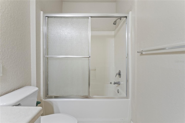 full bathroom with vanity, toilet, and combined bath / shower with glass door