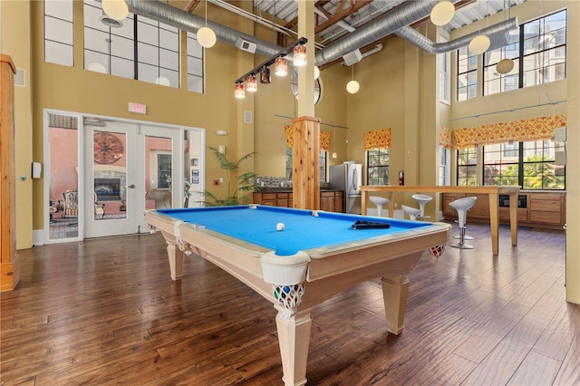 rec room featuring a high ceiling, hardwood / wood-style flooring, and billiards