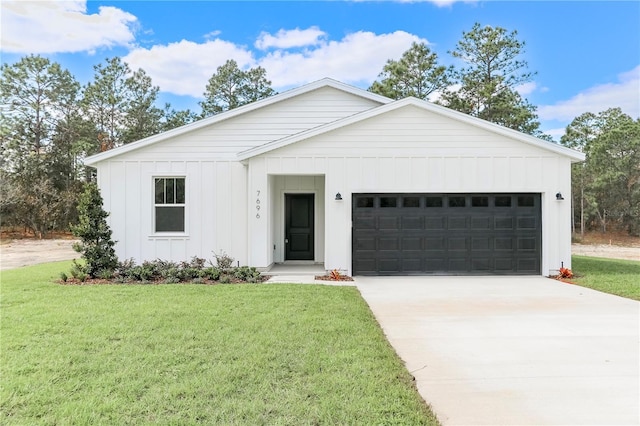 modern farmhouse featuring a garage and a front lawn