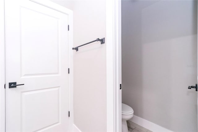 bathroom featuring tile patterned flooring and toilet