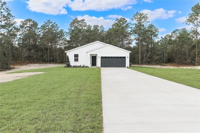 view of front of property featuring a garage and a front lawn