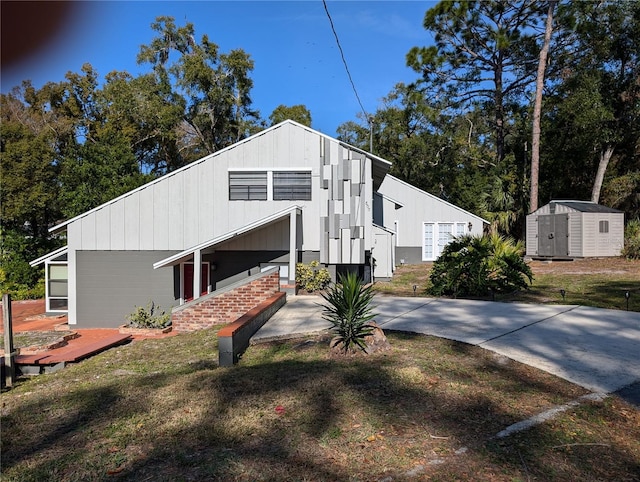 view of side of home with a storage shed