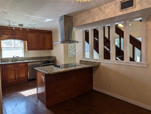 kitchen featuring dark wood-type flooring, sink, island range hood, stone counters, and stainless steel appliances