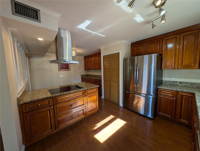 kitchen featuring dark wood-type flooring, stainless steel refrigerator, range hood, light stone countertops, and black electric cooktop