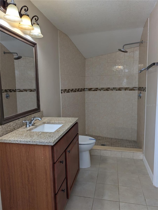 bathroom featuring toilet, vaulted ceiling, a textured ceiling, vanity, and tile patterned flooring