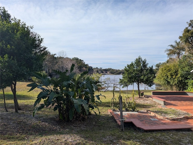 view of property's community featuring a yard and a water view