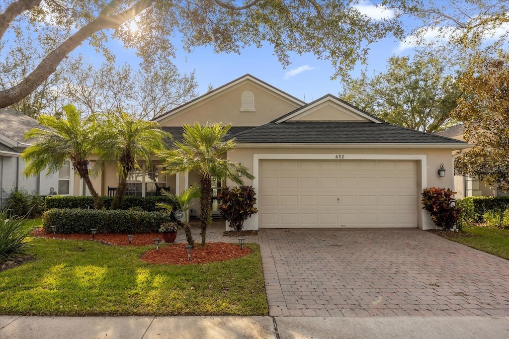 view of front of home with a garage and a front yard