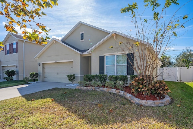 view of front of home with a garage and a front lawn