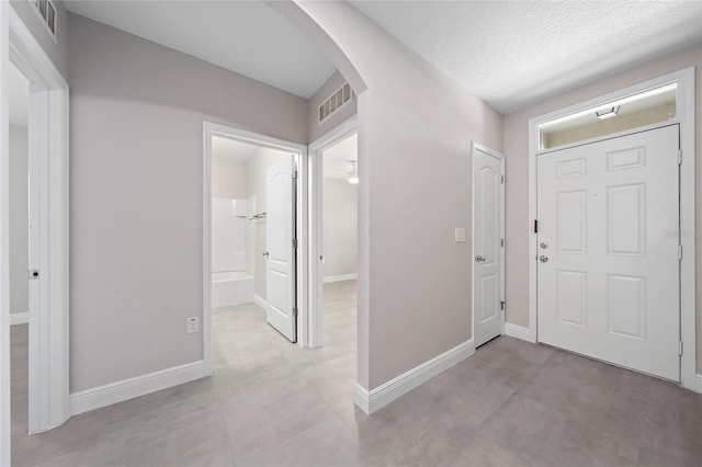 foyer entrance featuring a textured ceiling