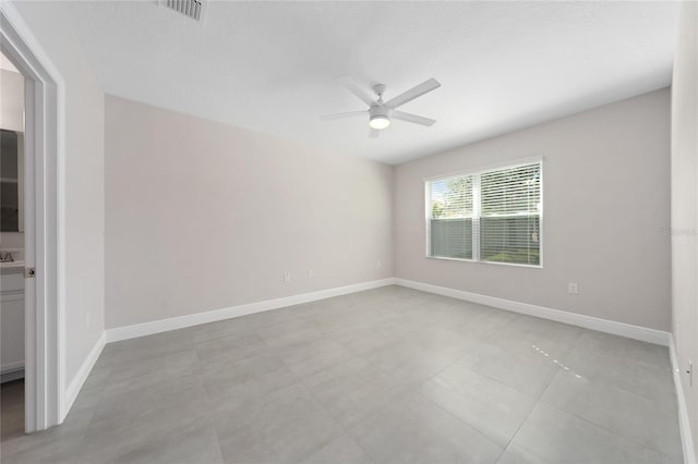 empty room with a textured ceiling and ceiling fan