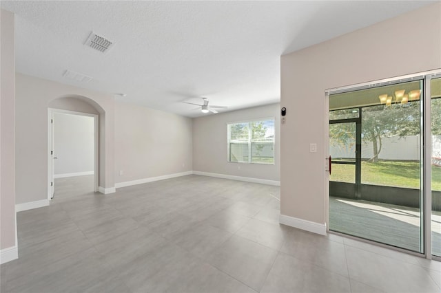 empty room featuring ceiling fan and a textured ceiling