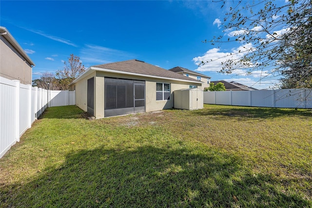 back of property with a yard and a sunroom