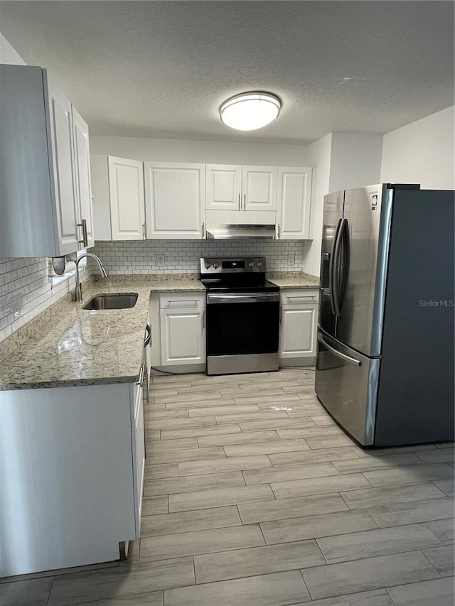 kitchen with stainless steel refrigerator with ice dispenser, sink, light stone counters, range with electric stovetop, and white cabinets