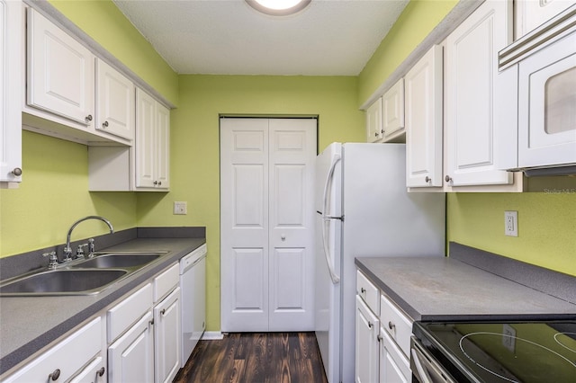 kitchen with white cabinetry, sink, white appliances, dark wood-type flooring, and a textured ceiling