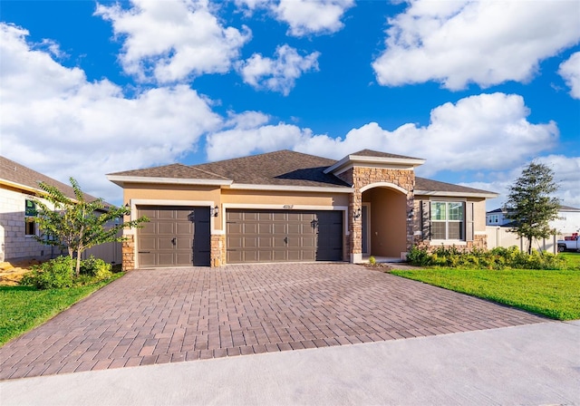 prairie-style house featuring a garage and a front yard