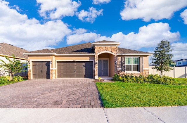 view of front of home featuring a garage and a front yard