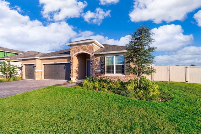 view of front facade with a garage and a front lawn