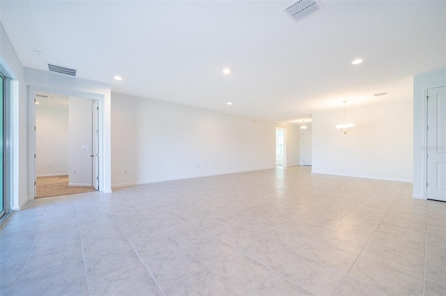 unfurnished room with a notable chandelier and light tile patterned floors