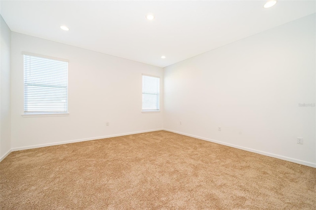 empty room featuring light colored carpet