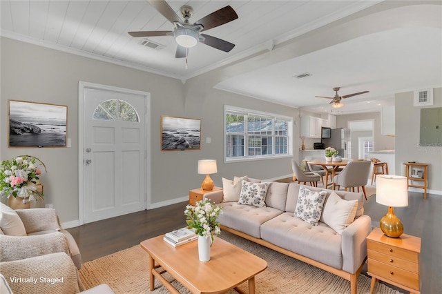 living room with crown molding, ceiling fan, and dark wood-type flooring