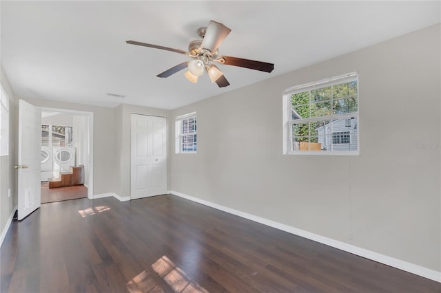 interior space featuring washer / dryer, dark wood-type flooring, and ceiling fan