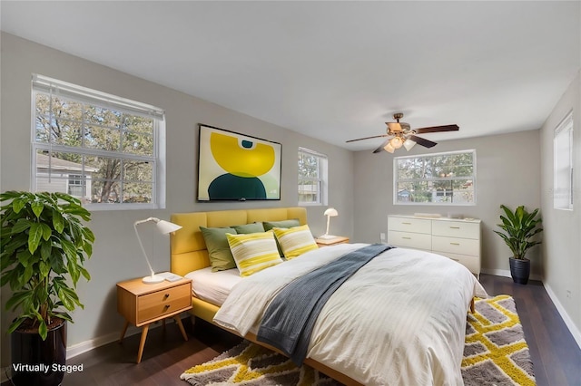 bedroom with dark wood-type flooring and ceiling fan