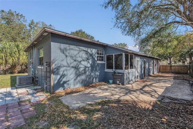 rear view of house featuring a patio and central air condition unit