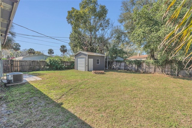 view of yard with central AC unit and a storage shed