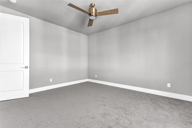 carpeted empty room featuring a textured ceiling and ceiling fan