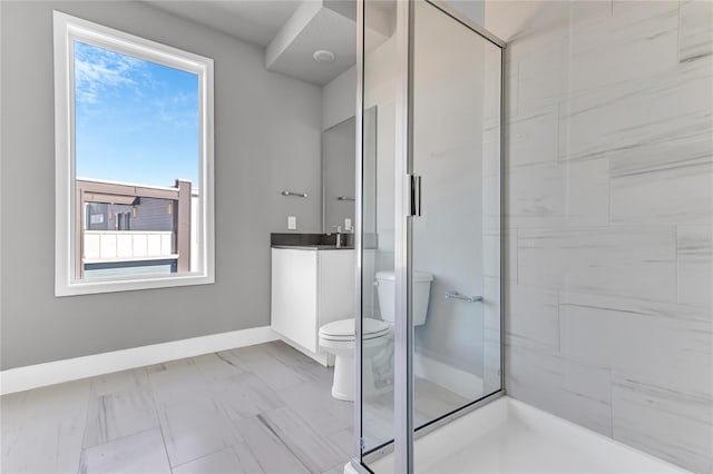 bathroom featuring sink, a healthy amount of sunlight, toilet, and a shower with door