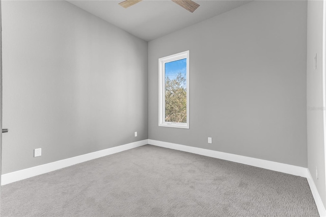 carpeted empty room featuring ceiling fan