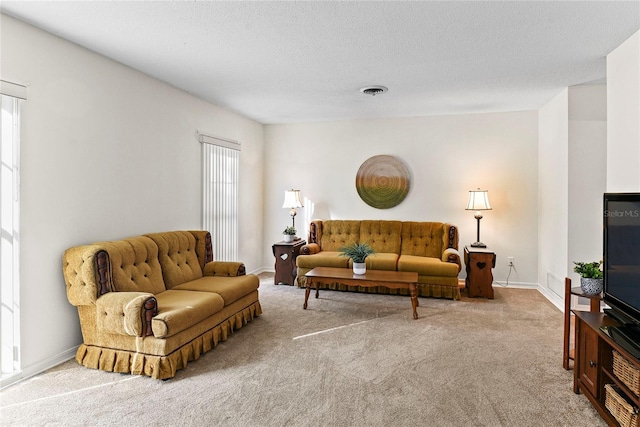 carpeted living room featuring a textured ceiling