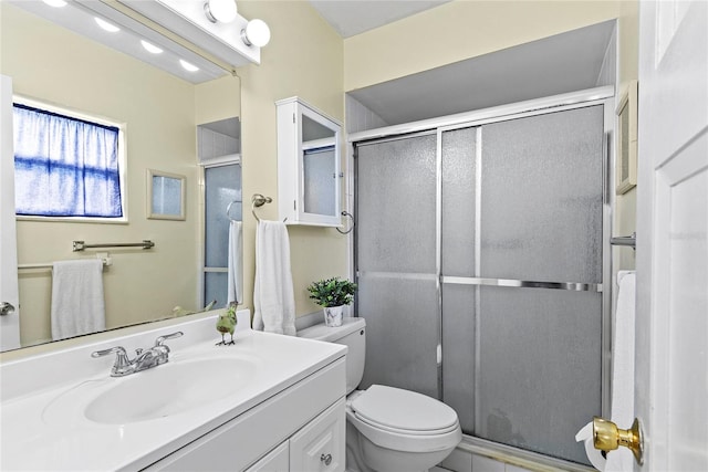 bathroom featuring walk in shower, vanity, and toilet