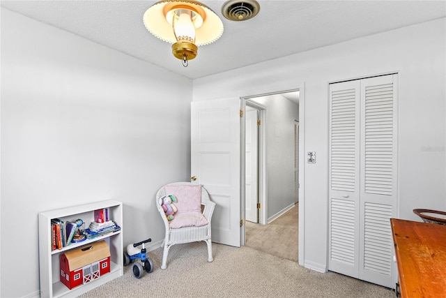 living area with light colored carpet