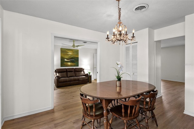 dining room with visible vents, baseboards, and wood finished floors