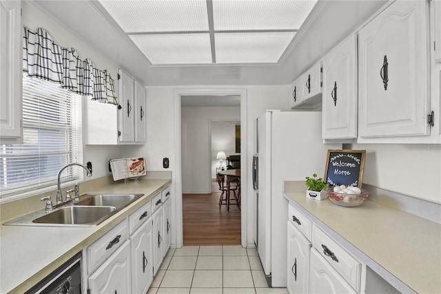 kitchen with a sink, white cabinetry, light tile patterned floors, and light countertops