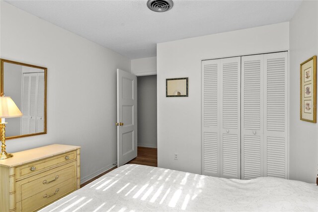 bedroom featuring visible vents and a closet