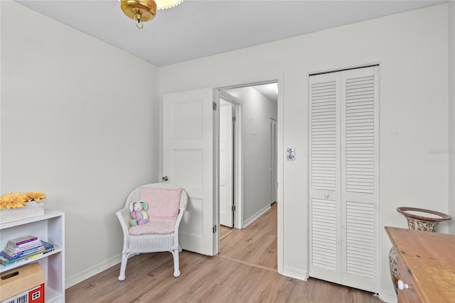 interior space featuring baseboards and light wood-style flooring