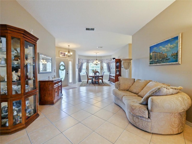 tiled living room featuring a chandelier