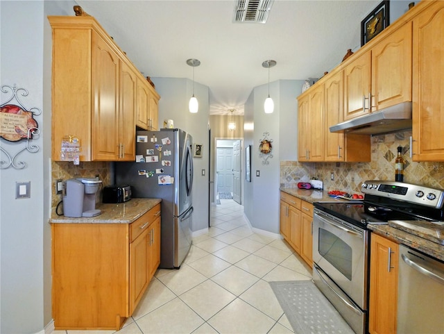 kitchen with backsplash, stainless steel appliances, light stone counters, light tile patterned flooring, and decorative light fixtures