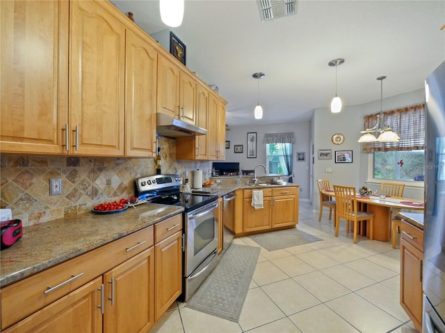 kitchen with decorative light fixtures, backsplash, light tile patterned floors, stainless steel appliances, and light stone countertops