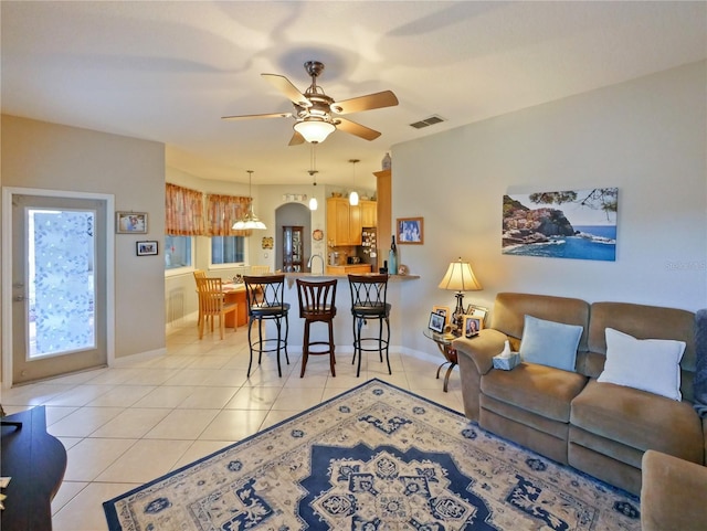 tiled living room featuring ceiling fan