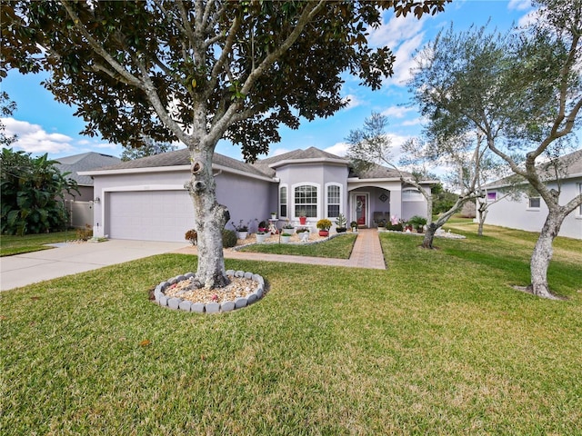 view of front of property featuring a garage and a front yard