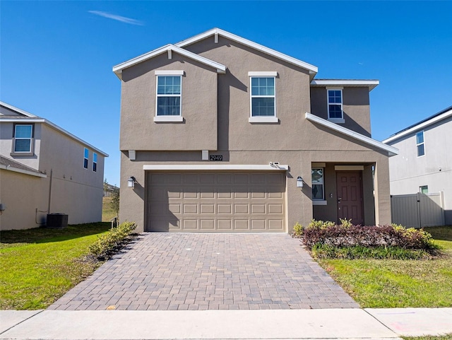 view of front property with central AC unit and a garage