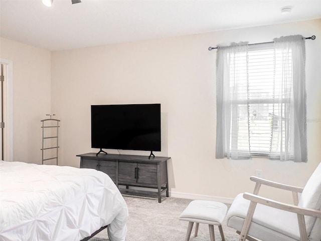 bedroom with multiple windows and carpet