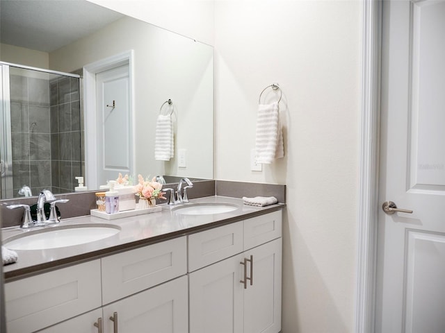 bathroom with vanity and a shower with shower door