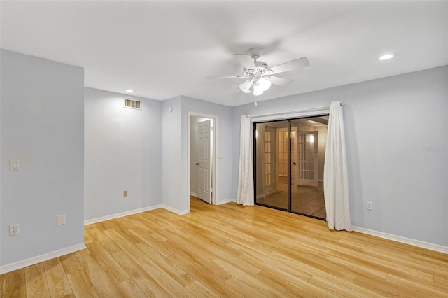 spare room featuring light hardwood / wood-style flooring, french doors, and ceiling fan