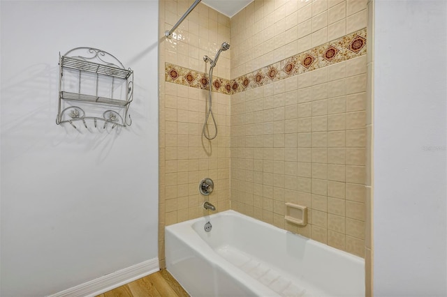 bathroom featuring tiled shower / bath and wood-type flooring